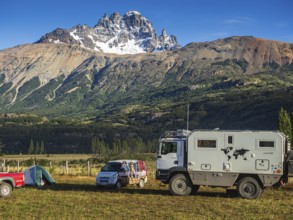 Tents on campsite in village Villa Cerro Castillo, expedition truck, mountain Cerro Castillo in the