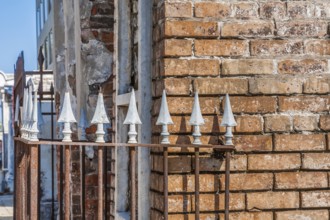 Arrowhead spikes on wrought iron fence at an above ground grave in St. Louis Cemetery No. 1 in New
