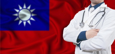 Taiwan Health Care Concept. Male Doctor on Taiwan Flag. Doctor With Crossed Arms on Taiwan Flag