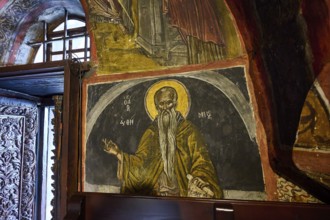 Orthodox holy picture with golden accents on a wall in a church, Inside the monastery, Agiou