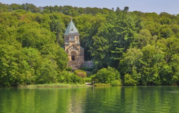 Votive chapel Memorial Chapel of St Ludwig on the lakeshore with wooden cross in the lake, the