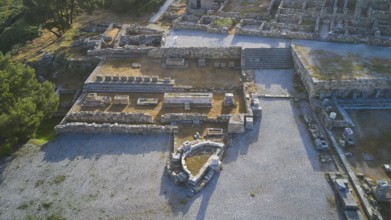 Drone shot, first morning light, overview of ancient ruins with wall remains in an archaeological