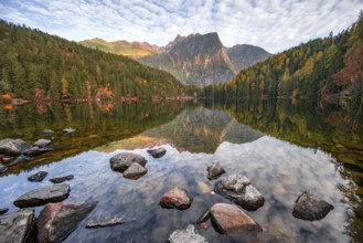 Mountain peaks of the Ötztal Alps reflected in Lake Piburger See, in autumn, near Ötz in Ötztal,