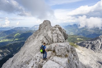 Mountaineer on a narrow rocky ridge, Watzmann crossing to Watzmann Mittelspitze, view of mountain