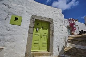 White house with light green door, blue sky, Mediterranean style, sunny day, Chora, main town