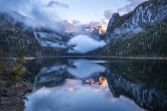 The Vordere Gosausee lake in autumn with a view of the Dachstein mountain range. The Gosaukamm on