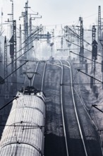 Deutsche Bahn AG tracks against the light. Overhead line, signals and infrastructure. Railway