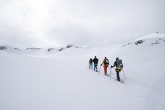 Group of ski tourers, Snowy mountain landscape, Bernese Alps, Bernese Oberland, Switzerland, Europe