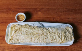 Delicious traditional Nicaraguan quesillo served on wooden table, View of a Nicaraguan quesillo