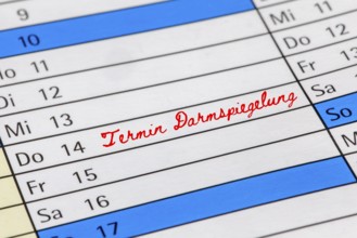 Symbolic image of colorectal cancer screening (early detection) : Calendar with note of an
