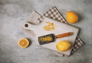 Grated lemon zest, on a cutting board, with a grater, top view, no people