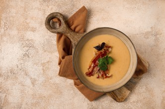Pumpkin cream soup, curry, fried bacon, top view, no people