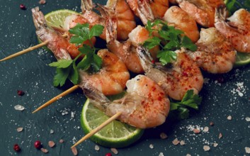 Shrimp kebab, with spices, lime, on wooden skewers, top view, no people