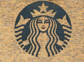 Starbucks coffee logo symbol stencilled onto wall of yellow bricks, Liverpool, Merseyside, England,