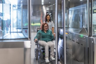 Disabled woman in electric wheelchair and chinese friend entering to the metro station