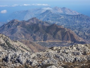 Deep view into the rough mountain and valley structure with blue and brown shades of northern