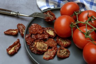 Fresh and dried tomatoes on a plate, Solanum lycopersicum