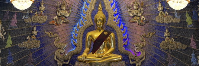 Golden Buddha statue with tunic, Bhumispara-mudra, Buddha Gautama at the moment of enlightenment,