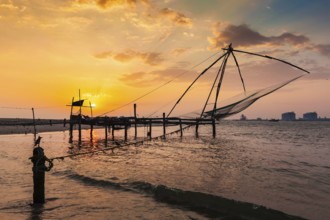 Kochi chinese fishnets on sunset in Fort Kochin, Kochi, Kerala, India, Asia