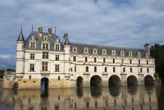 Historic castle with towers and water reflection under a cloudy sky, Chenonceau Castle, Château de