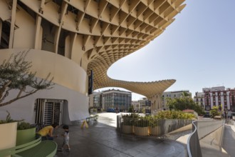 Metropol Parasol with people in the foreground and bright sunshine in the city, Seville