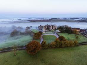 Raglan Castle in the fog at dawn from a drone, Monmouthshire, Wales, England, United Kingdom,