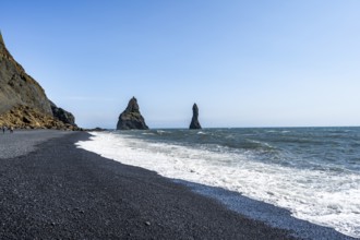 Black beach with cliffs, rock Reynisdrangar in the water, at Reynisfjara beach, Vik, South Iceland,