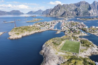 Aerial view over fishing village Henningsvaer, football stadium on rocky island, Lofoten, Norway,