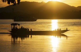 Boats in the Brahmaputra river, during sunset in Guwahati, Assam, India on 1 August 2023