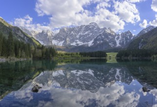 The Mangart mountain range reflected in Lake Fusine, Tarvisio, province of Udine, Italy, Europe