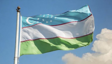 Flags, the national flag of Uzbekistan flutters in the wind