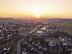 Sunset over a small town with crossroads and industrial buildings, Althengstett, Calw district,