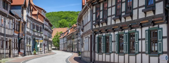 Street with half-timbered houses and cobblestones winds through the old town, Stolberg im Harz,