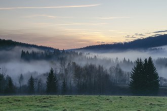 Autumnal evening mood with fog in the valley and in the forests of the Bavarian Forest National