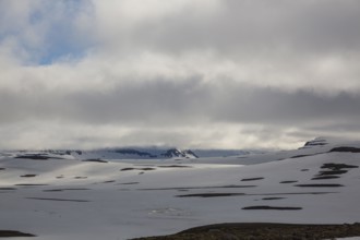 Snowfields at the Heidarvatn lake between Seydisfjördur and Eglisstadur in E Iceland