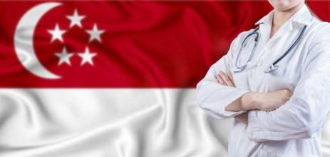 Doctor with crossed arms on Singapore flag. Singapore Health and Care concept. Female doctor on