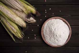 Corn cobs, corn flour, on a wooden table, top view, close-up, rustic, selective focus, dairy corn