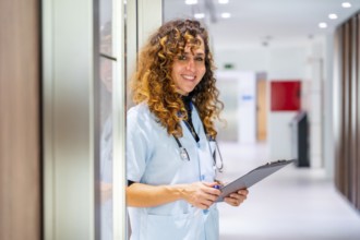 Portrait of a nurse holding a medical record smiling at camera