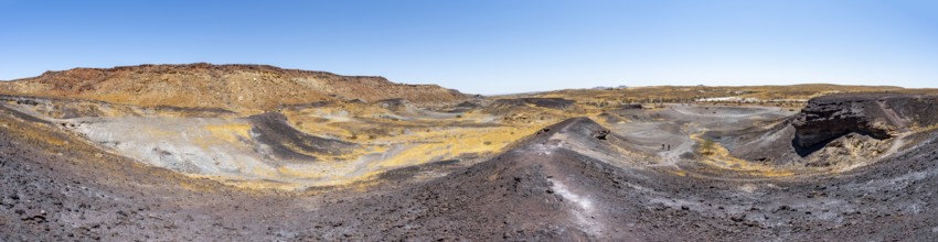 Dry landscape with yellow grass and black volcanic hills, Burnt Mountain, Damaraland, Kunene,