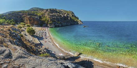 Panoramic view of Ahata Beach with clear, turquoise-coloured sea and steep cliffs, Ahata Beach,
