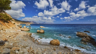 Quiet beach with large rocks framed by deep blue water and a wide sky, Kato Lakkos Beach, still