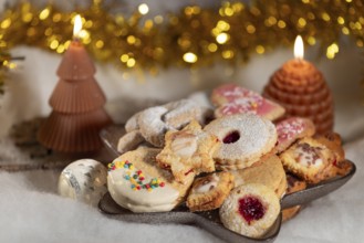 Colourful selection of biscuits with two burning candles