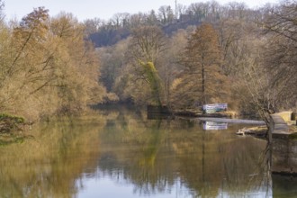 Winter river landscape with bare trees and calm water reflection, Schwäbisch Hall, Germany, Europe