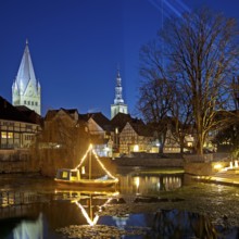 Large pond, St. Patrokli Cathedral and St. Peter's Church in the evening during winter sunshine,