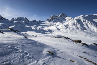 Mountain peak Piz Kesch with snow, view at the Kesch hut in winter, Grisons Haute Route, Albula