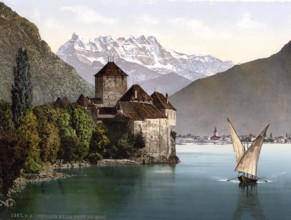 A lateen-sail barque on Lake Geneva near the Château de Chillon and with the Dents du Midi in the