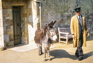 Donkey and animal keeper, Carisbrooke, Isle of Wight, England. 1973