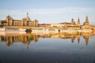 Silhouette of the Old Town with reflection in the Elbe in the morning, steamboats on the