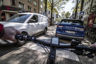 Cycling in the city, inner-city street, cycle lane, bicycles have priority, two-lane traffic with