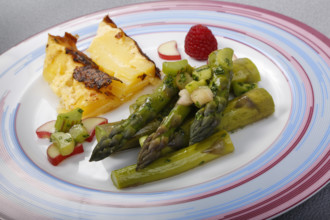 South German cuisine, green asparagus with rhubarb vinaigrette and potato gratin, healthy,